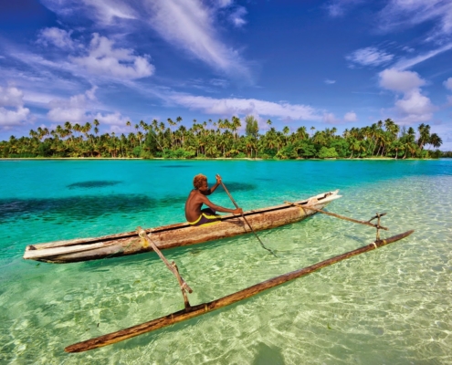 A boy canoeing in the ocean - Papua New Guinea