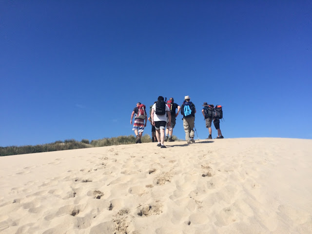 Hiking up a sand dune en route to Newquay - South West Coast Path