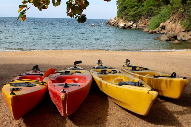 Kayaks awaiting usage on the main beach at Mumbo Island