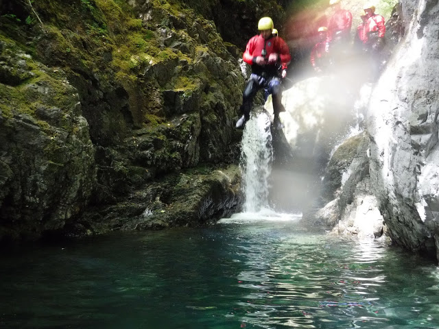 Leaping into the air for the first rock jump in Church Beck, Coniston