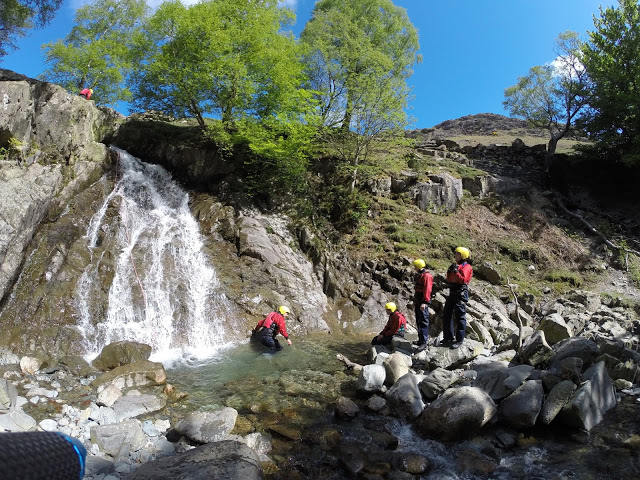 Landing into the pool at the bottom of the first waterfall - Canyoning in Coniston, Lake District